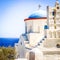 Traditional bells tower and blue dome  of the orthodox white churches, Sifnos island, Greece