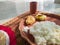 Traditional bengali home cooked thali or platter served on plate made of clay. boiled rice, lentil and potato. authentic indian