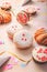 Traditional Berliner for carnival and party. German Krapfen or donuts with streamers and confetti. Colorful carnival or birthday