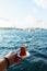 Traditional black Turkish tea in a glass on a plate in the hands with a view of the Bosporus and Istanbul.