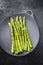 Traditional blanched green asparagus on a cast iron design plate