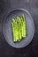 Traditional blanched green asparagus on a cast iron design plate