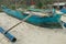 Traditional boat perahu. Wooden fishing boat on a sandy beach Mawun. Blue fishing boat on the island of Lombok in