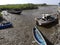 Traditional boats beached in the tidal rivuket of Revas near Alibag