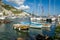 Traditional boats and modern yachts docked at Amalfi marina