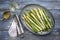 Traditional boiled green and white asparagus as side dish on a design plate