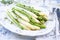 Traditional boiled green and white asparagus offered as side dish on a classic bone china style plate