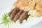 Traditional bosnian food cevapi with flat bread and onion