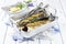 Traditional braised Atlantic loup de mer with lemon slice and herbs in a design skillet