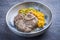 Traditional braised Italian ossobuco alla Milanese with saffron risotto and herbs in white wine meat sauce