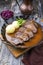 Traditional braised marinated German Sauerbraten from beef with potato dumplings and blue kraut in spicy brown sauce