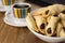 Traditional Brazilian buttered cookies stuffed with guava paste called goiabinha ou beliscÃ£o in a white bowl in wood bakground