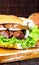 Traditional Brazilian sandwich of bread with sausage, tomato, onion and lettuce. Crispy salt bread with roasted or fried sausage