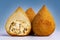 Traditional Brazilian snacks on a blue gradient background - coxinha