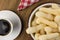 Traditional Brazilian starch biscuit called biscoito de polvilho in a basket in a wood background coffe table seen from above