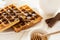 Traditional breakfast: coffee, belgian waffles with honey and chocolate sauce