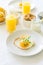 Traditional breakfast with fried egg, yogurt, homemade muffins, citrus curd and orange juice