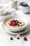 Traditional breakfast - oatmeal porridge with berries. AI generated