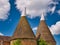 Traditional brick built oast houses with white chimneys in Kent, UK. Taken on a sunny day with blue sky in summer