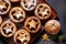 Traditional British Christmas Pastry Home Baked Mince Pies with Apple Raisins Nuts Filling on rustic wood table. Golden Shortcrust