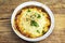 Traditional british cottage pie bowl meal on rustic wood table