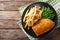 Traditional British food: Fish and chips with green peas close-up on a plate. Horizontal top view