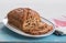 Traditional British fruit loaf on an oval plate on a blue board