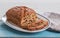 Traditional British fruit loaf on an oval plate on a blue board