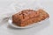 Traditional British fruit loaf on an oval plate on a pale background