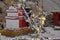 Traditional Buddhist chortens stand in the Himalayan mountains, with garlands of flags.