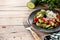 Traditional Bulgarian shopska salad with tomato,cucumber and bulgarian sirene cheese on wooden table