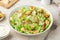 Traditional Caesar salad with lettuce, roasted chicken,  croutons and cheese in