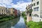 Traditional canal street with bright colorful buildings in Padova, Italy