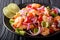 Traditional ceviche seafood with vegetables and lime close up on