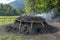 Traditional Charcoal making in Gozd Martuljek. Slovenia. Smoking mound of wood