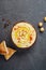 Traditional chickpea hummus bowl with pita flatbread, chickpeas and spices on gray background