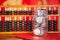 Traditional Chinese abacus beads on a festive red background and a glass bottle full of coins