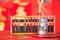 Traditional Chinese abacus beads on a festive red background and a glass bottle full of coins