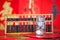 Traditional Chinese abacus beads on a festive red background and a glass bottle full of coins