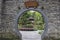 Traditional Chinese round door in stone brick wall, entrance to a garden at Du Fu Thatched Cottage