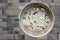 Traditional chinese stone fresco representing plants on a brick wall.