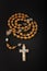 Traditional christian holy religious wooden rosary isolated on black background