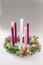 Traditional christian religious advent wreath with 5 candles, one candle burning