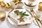Traditional Christmas Eve wafer on elegant plate with fir and golden star