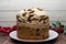 Traditional Christmas Panettone. Famous Italian dessert with Christmas ornaments isolated on wooden background