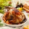 Traditional Christmas roasted chicken with tangerines and apples