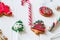 Traditional Christmas sweets on white wooden background. Candy cane, round snowflake and ginger man, star lollipop. Top