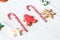 Traditional Christmas sweets on white wooden background. Candy cane, round snowflake and ginger man, star lollipop. Top