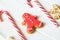 Traditional Christmas sweets on white wooden background. Candy cane, round snowflake and ginger man, star lollipop. Top