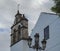 Traditional church stone bell tower and street lamp in Puerto de la cruz, Spain, Canary islands, Tenerife, blue sky